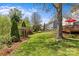 Expansive backyard with manicured lawn, mature trees, and a charming pergola create a private oasis at 9637 Stoney Hill Ln, Charlotte, NC 28277