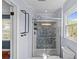 This bathroom features a beautifully tiled shower, glass door, and tiled floors at 9637 Stoney Hill Ln, Charlotte, NC 28277