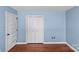 This bedroom features a blue palette, hardwood floors, and ample closet space at 9637 Stoney Hill Ln, Charlotte, NC 28277