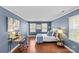 This bedroom features a charming blue palette, hardwood floors, and bright natural light at 9637 Stoney Hill Ln, Charlotte, NC 28277