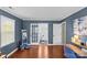 Bedroom with hardwood floors and a view of an ensuite bathroom through the beautiful french doors at 9637 Stoney Hill Ln, Charlotte, NC 28277