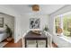 Bright dining room featuring a modern table and chairs with art, natural light, and a decorative light fixture at 9637 Stoney Hill Ln, Charlotte, NC 28277