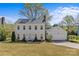 Charming two-story home featuring a well-manicured lawn, attached garage, and classic colonial architecture under a blue sky at 9637 Stoney Hill Ln, Charlotte, NC 28277