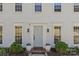 Welcoming front entrance with a light blue door framed by potted plants and elegant lighting fixtures creating curb appeal at 9637 Stoney Hill Ln, Charlotte, NC 28277