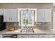 Bright kitchen featuring granite countertops, tile backsplash, and stainless steel appliances at 9637 Stoney Hill Ln, Charlotte, NC 28277