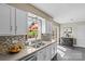 Bright kitchen with stainless steel sink, granite countertops, and tile backsplash at 9637 Stoney Hill Ln, Charlotte, NC 28277