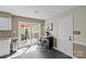 Bright kitchenette with a breakfast bar, sliding glass door to deck, and outdoor grill at 9637 Stoney Hill Ln, Charlotte, NC 28277