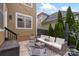 Inviting backyard patio featuring an outdoor sectional sofa and ambient string lights perfect for entertaining at 1117 Cedar Park Dr, Pineville, NC 28134
