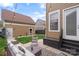 Relaxing backyard patio with string lights, stylish outdoor furniture, and a well-manicured lawn at 1117 Cedar Park Dr, Pineville, NC 28134
