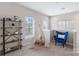 Bright bedroom featuring a decorative teepee, accent chair, and stylish shelving for storage and display at 1117 Cedar Park Dr, Pineville, NC 28134