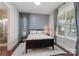 Comfortable bedroom with a black bed frame, area rug, and natural lighting at 1117 Cedar Park Dr, Pineville, NC 28134
