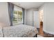 Cozy bedroom featuring a patterned comforter, wood floors, and natural light at 1117 Cedar Park Dr, Pineville, NC 28134