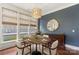 Inviting dining room featuring a round table, stylish light fixture, and large windows, perfect for entertaining at 1117 Cedar Park Dr, Pineville, NC 28134