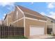 Exterior showcasing a two-car garage, durable siding, privacy fence, and a well-maintained lawn at 1117 Cedar Park Dr, Pineville, NC 28134