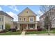 Inviting two-story home with a cozy front porch and beautifully landscaped yard at 1117 Cedar Park Dr, Pineville, NC 28134