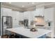 Modern kitchen showcasing white cabinetry, stainless steel appliances, and a marble countertop at 1117 Cedar Park Dr, Pineville, NC 28134