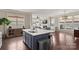 Open-concept kitchen featuring a large island, modern appliances, and a seamless connection to the living area at 1117 Cedar Park Dr, Pineville, NC 28134