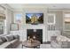 Living room featuring a fireplace with white mantel and built-in cabinets at 1117 Cedar Park Dr, Pineville, NC 28134