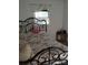 Bedroom view showcasing a decorative metal bed frame, floral bedding, and a window with a curtain at 1204 Borders Rd, Shelby, NC 28150