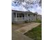 Charming exterior view of the home with a blue door, white porch, and bicycle parked out front at 1204 Borders Rd, Shelby, NC 28150