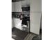 Modern kitchen featuring stainless steel appliances, white cabinetry, and laminate floors for a clean, updated look at 1204 Borders Rd, Shelby, NC 28150