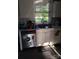 Kitchen sink area featuring white cabinets, stainless steel dishwasher, and a window with a view at 1204 Borders Rd, Shelby, NC 28150