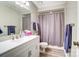 Bathroom featuring a white vanity with storage, a mirror with vanity lighting, and a gray shower curtain at 1212 Robinhood Cir, Charlotte, NC 28227