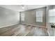 Light-filled bedroom with wood floors, neutral walls, and two windows providing ample natural light at 1212 Robinhood Cir, Charlotte, NC 28227