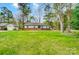 Front exterior view of a home with green lawn, and mature shade trees at 1212 Robinhood Cir, Charlotte, NC 28227