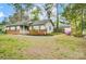 Beautiful ranch-style home with brick accents, a covered porch, a detached garage, and a fenced yard in a wooded setting at 1212 Robinhood Cir, Charlotte, NC 28227