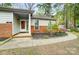 Inviting home entrance with a brick foundation, walkway, and colorful landscaping at 1212 Robinhood Cir, Charlotte, NC 28227