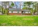 Charming single-story home with a brick foundation, a well-maintained lawn, and mature trees in a desirable neighborhood at 1212 Robinhood Cir, Charlotte, NC 28227