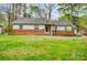 Charming single-story home featuring a brick foundation and well-manicured front lawn at 1212 Robinhood Cir, Charlotte, NC 28227