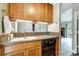 Kitchen featuring wood cabinets, tile countertops, and modern appliances seamlessly blending style and functionality at 1212 Robinhood Cir, Charlotte, NC 28227