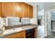 Updated kitchen showcasing tile countertops, wood cabinetry, and a seamless transition to the living area at 1212 Robinhood Cir, Charlotte, NC 28227