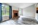 Bright living room featuring modern floors, a brick fireplace, and access to the backyard at 1212 Robinhood Cir, Charlotte, NC 28227