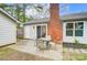 Patio with outdoor seating and view of the house with chimney and side yard at 1212 Robinhood Cir, Charlotte, NC 28227
