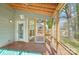 A view of a screened-in porch with wooded floors and a view of the yard at 14130 Misty Brook Ln, Charlotte, NC 28273