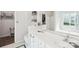 Bright bathroom with double vanity, white cabinets, and a view to the bedroom at 14130 Misty Brook Ln, Charlotte, NC 28273