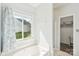 Bright bathroom with a luxurious tub, window view, and linen storage space at 14130 Misty Brook Ln, Charlotte, NC 28273