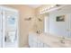 Spacious bathroom with double sink vanity, white cabinets, and a large mirror at 14130 Misty Brook Ln, Charlotte, NC 28273