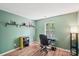 Bedroom featuring modern desk and shelves, painted a calming green color at 14130 Misty Brook Ln, Charlotte, NC 28273