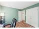 Cozy bedroom with wood floors and a closet, painted a calming green color at 14130 Misty Brook Ln, Charlotte, NC 28273