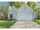 Traditional home with a two car garage and well-maintained lawn at 14130 Misty Brook Ln, Charlotte, NC 28273