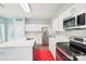 Modern kitchen featuring white cabinets, stainless steel appliances, and quartz countertops at 14130 Misty Brook Ln, Charlotte, NC 28273