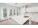Bright and airy kitchen with stainless steel appliances, white cabinets and quartz countertops at 14130 Misty Brook Ln, Charlotte, NC 28273