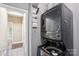 Efficient laundry area with stacked washer and dryer, maximizing space in the home at 14130 Misty Brook Ln, Charlotte, NC 28273
