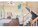 Spacious living room featuring an adjacent dining area and staircase to the upper level at 14130 Misty Brook Ln, Charlotte, NC 28273