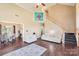 Open living room with hardwood floors, comfortable seating, and staircase to upper level at 14130 Misty Brook Ln, Charlotte, NC 28273