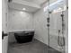 Modern bathroom with standalone tub, glass shower and marble tile throughout at 143 Mills Garden Rd, Statesville, NC 28625